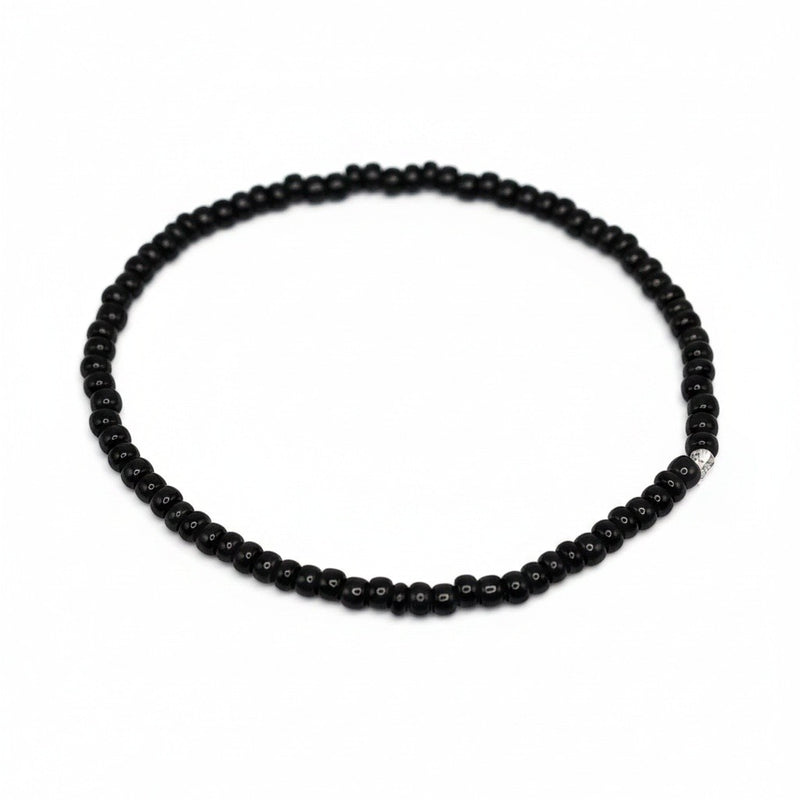 Handmade by Erika Liesel minimalist stretch bracelet featuring glossy 3mm black glass beads on a durable elastic cord.