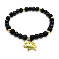 Handmade by Erika Liesel Buena Suerte stretch bracelet with matte and glossy black beads and a gold elephant charm.