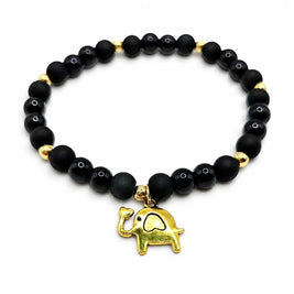 Handmade by Erika Liesel Buena Suerte stretch bracelet with matte and glossy black beads and a gold elephant charm.