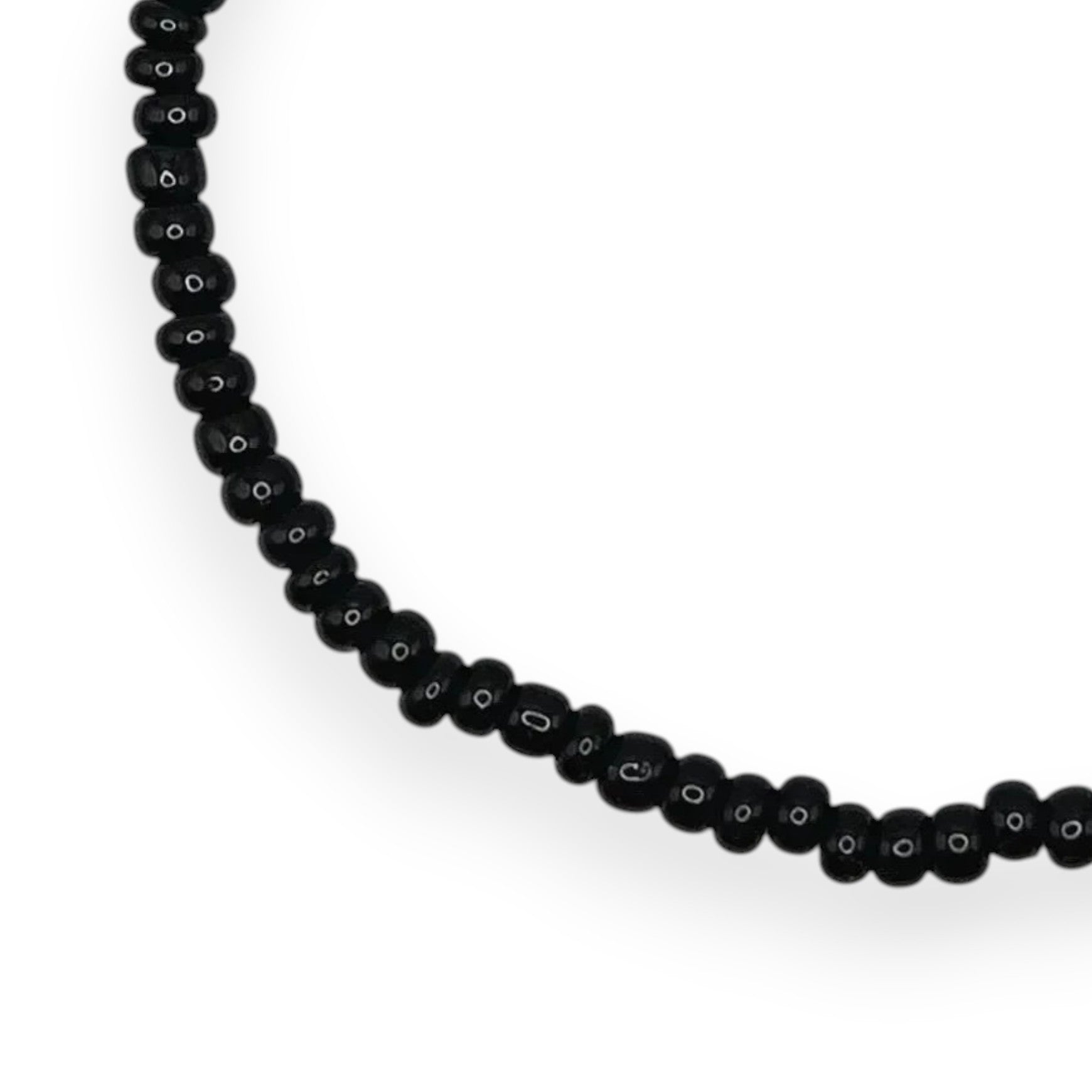Handmade by Erika Liesel minimalist stretch bracelet featuring small glossy black glass beads on an elastic cord
