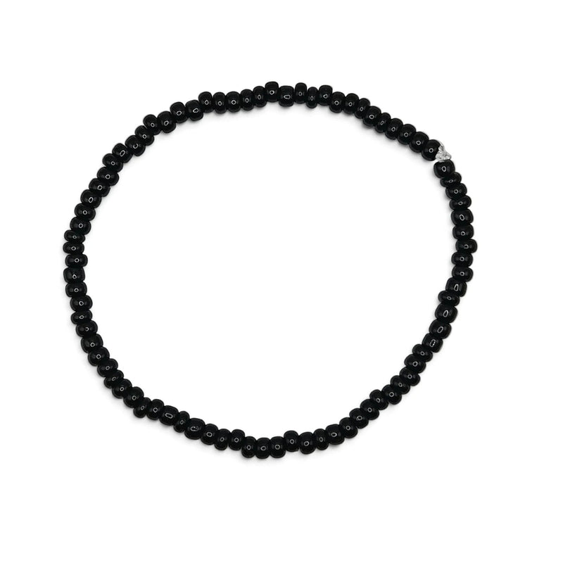 Handmade by Erika Liesel minimalist stretch bracelet featuring glossy 3mm black glass beads on a durable elastic cord.