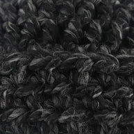 Close-up of a Handmade by Erika Liesel black and grey marled crochet beanie showing the soft, textured yarn detail.