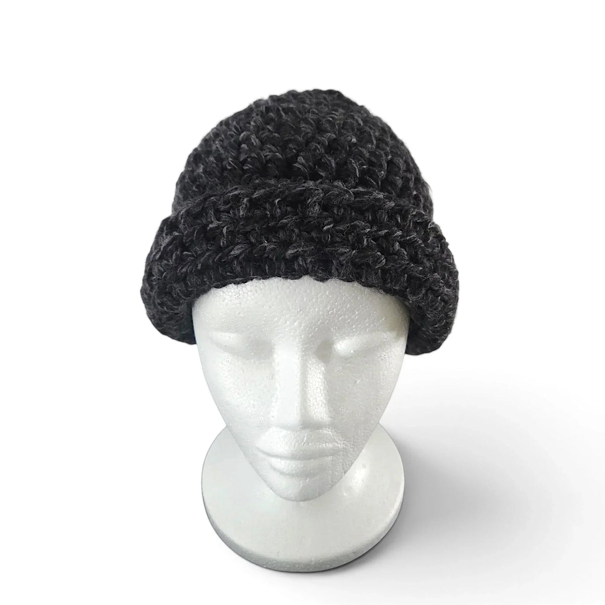 Handmade by Erika Liesel black crochet beanie with a cuffed design on a white mannequin head
