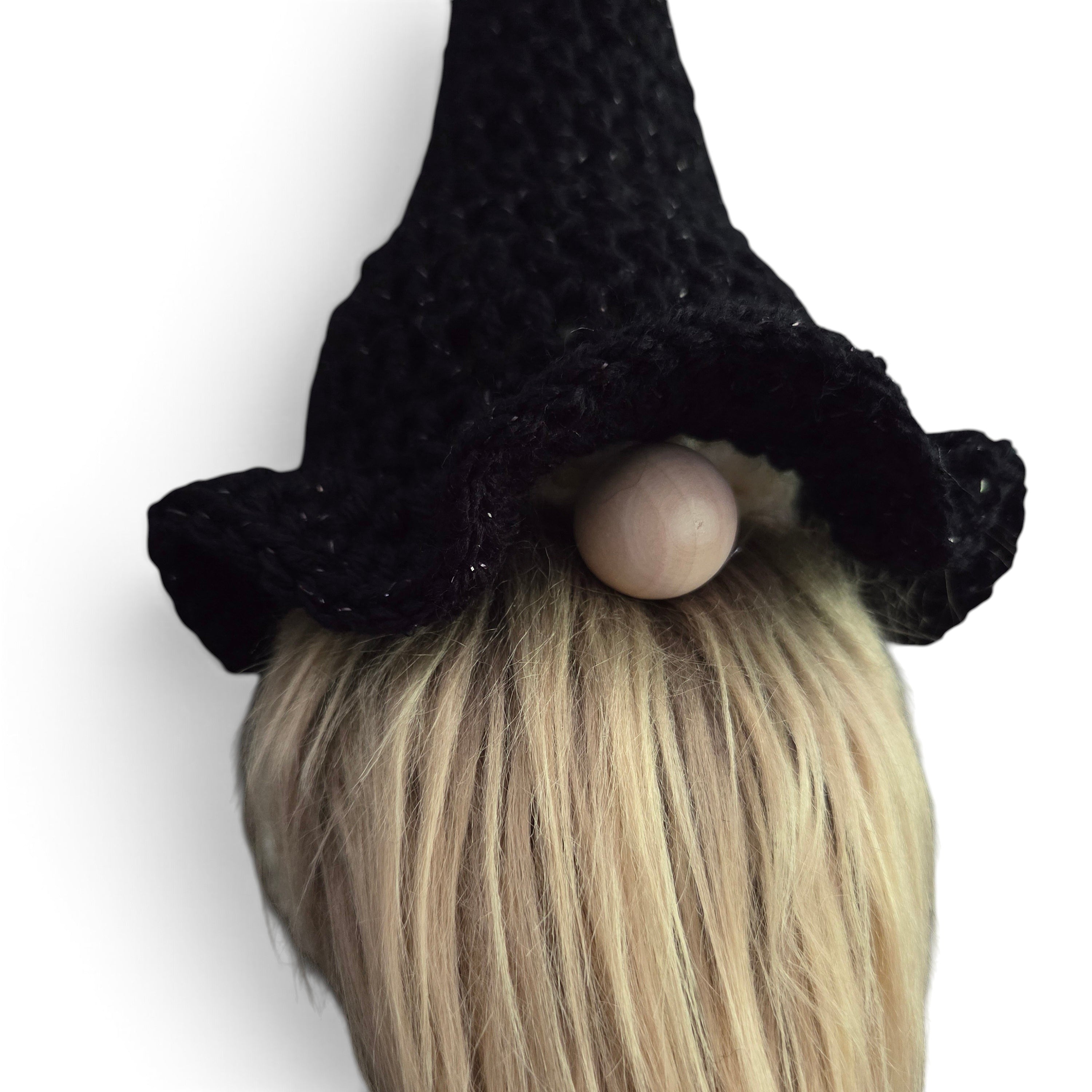 Handmade by Erika Liesel black crochet witch hat with subtle shimmer on a seasonal gnome with a blonde beard