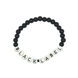 Handmade by Erika Liesel Black Label stretch bracelet with black glass beads and white letter beads on elastic cord.