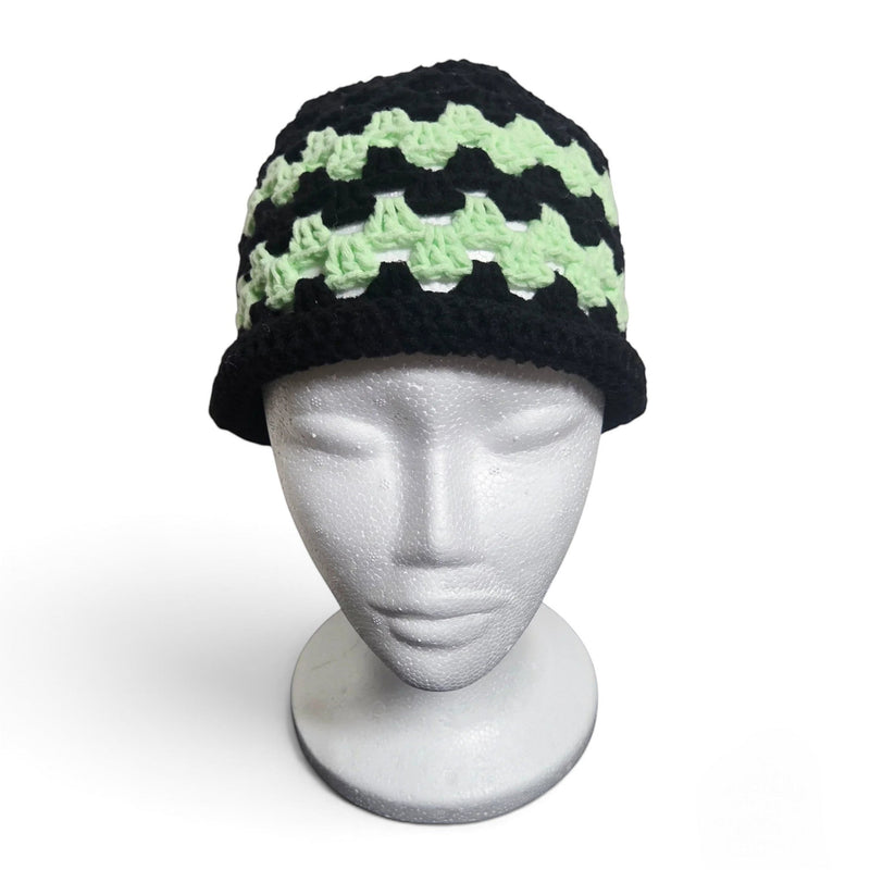 Handmade by Erika Liesel brimless crochet bucket hat in black and mint green on a white mannequin head