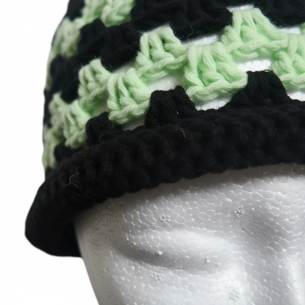 Handmade by Erika Liesel crochet brimless bucket hat in black and mint green with a textured, breathable design.