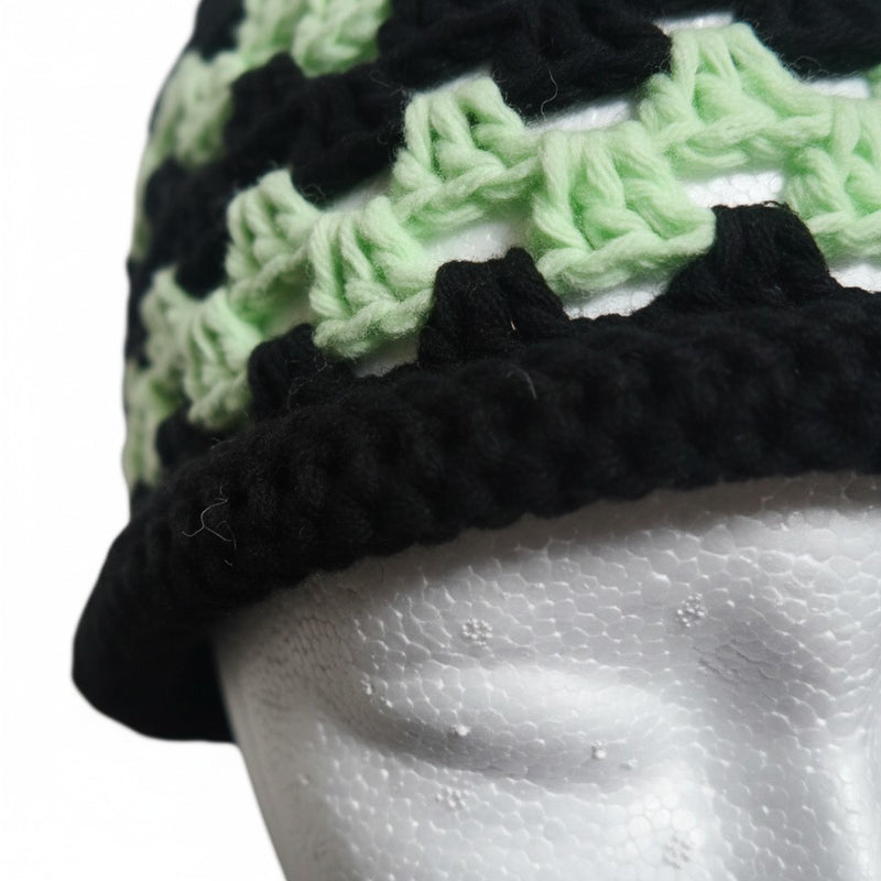 Handmade by Erika Liesel crochet brimless bucket hat in black and mint green with a textured, breathable design.