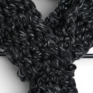Handmade by Erika Liesel black and white marled crochet keyhole scarf with a soft, textured yarn knit design.