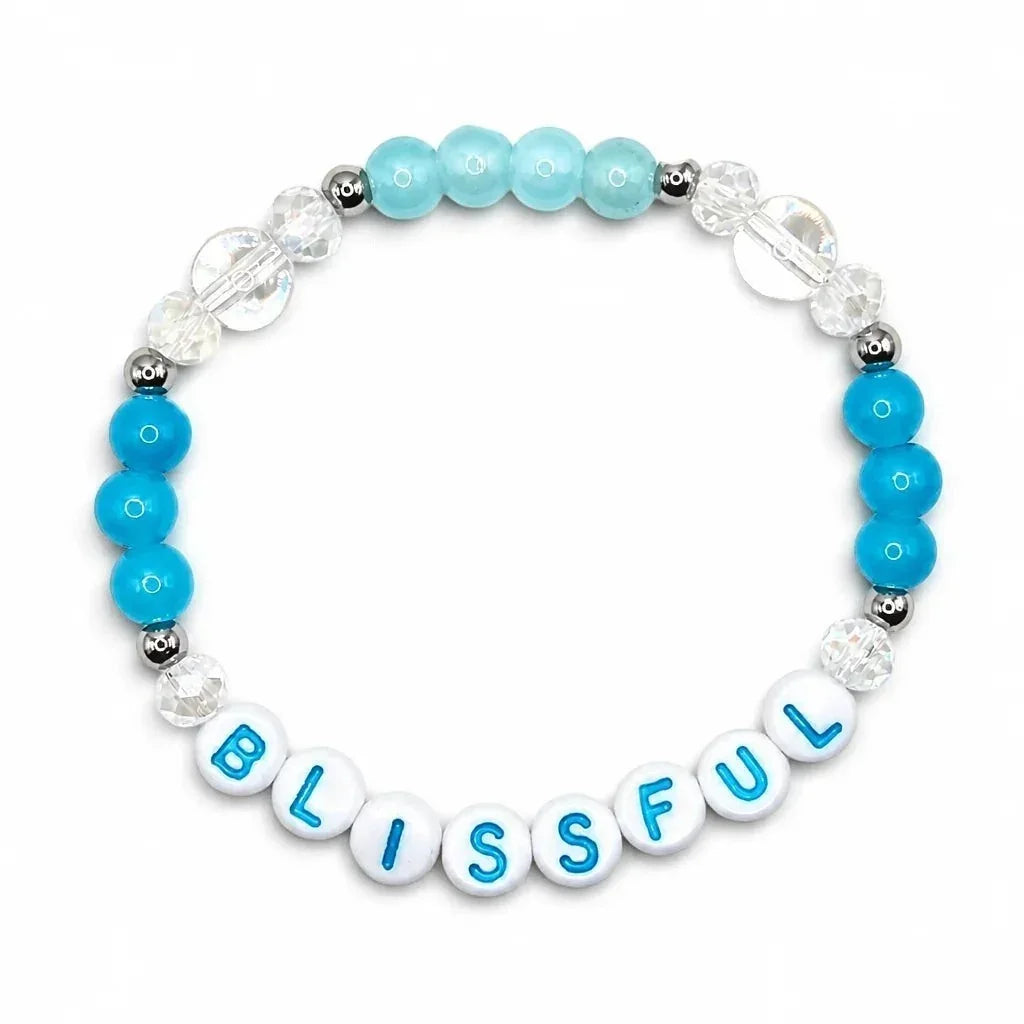 Handmade by Erika Liesel Blissful stretch bracelet with blue crystal glass beads and sterling silver accents.