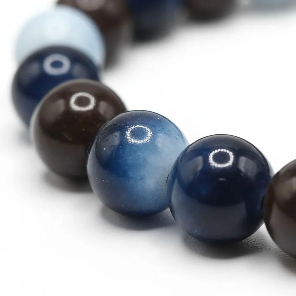 Handmade by Erika Liesel Nightfall bracelet featuring polished dark blue and brown glass beads on a stretch cord.