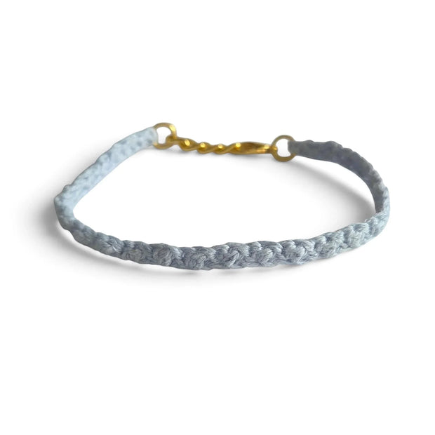 Delicate light blue crocheted bracelet with gold clasp, handmade for everyday comfort and style.