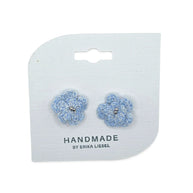 Handmade by Erika Liesel Bloom crochet flower earrings in light blue with silver bead accents on a display card.