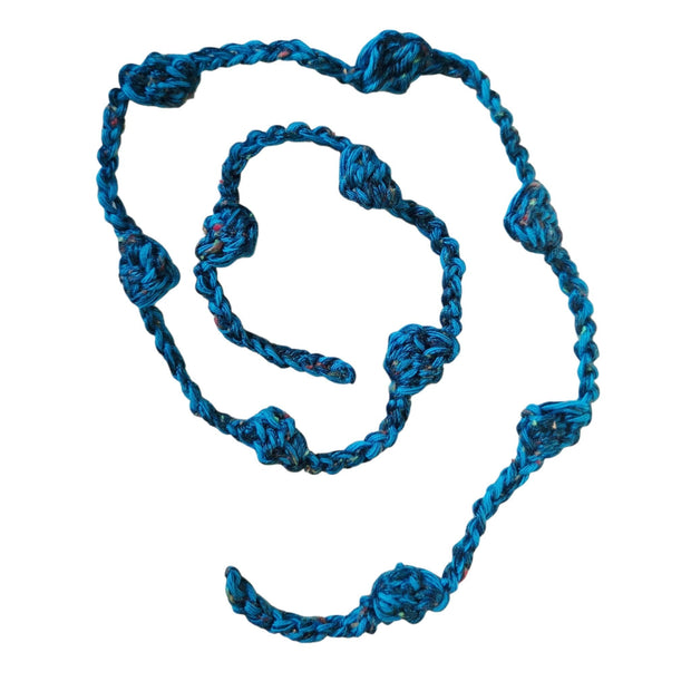 Handmade by Erika Liesel blue crochet garland with textured yarn knots for cozy home decor and shelf styling.