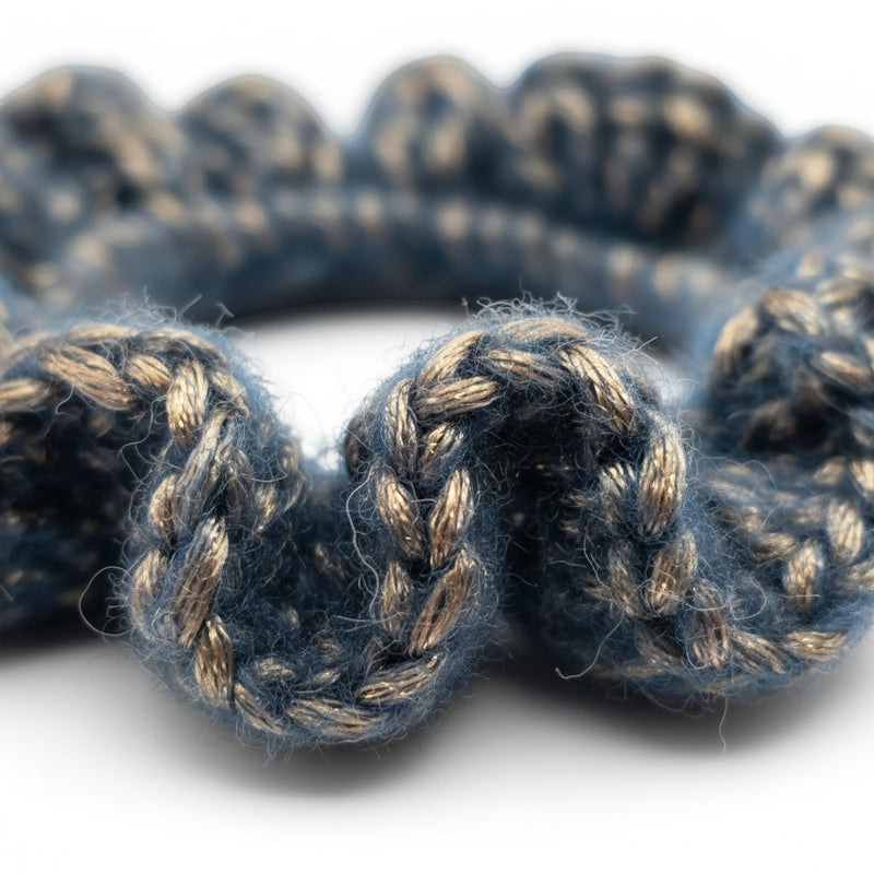 Handmade by Erika Liesel Luxe Touch crochet scrunchie in blue and metallic gold yarn with a soft textured finish.