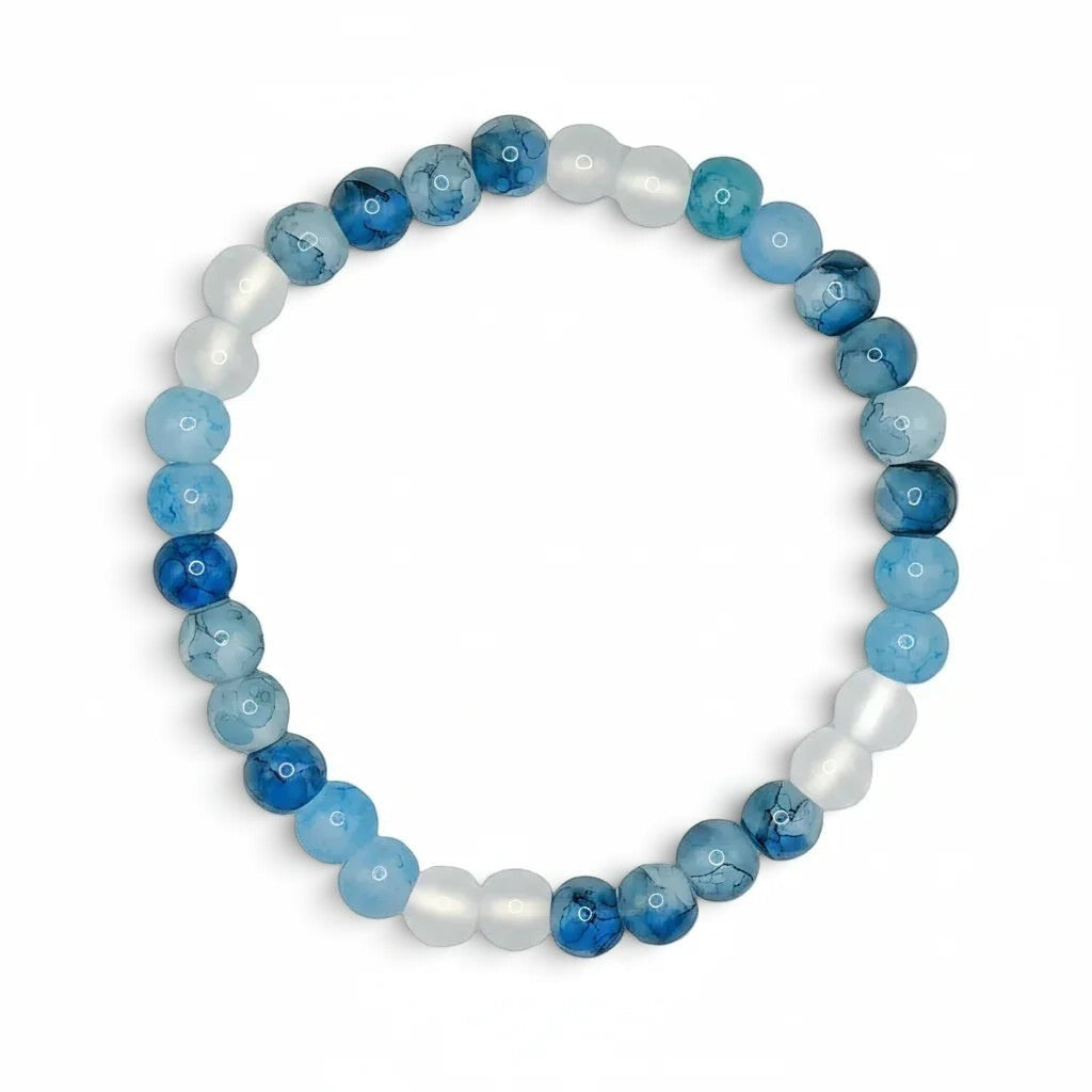Handmade by Erika Liesel Blue Horizon stretch bracelet featuring marbled pale blue, icy white, and deep blue glass beads