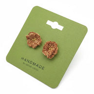 Handmade by Erika Liesel brown crochet flower stud earrings with gold bead centers on a green display card.