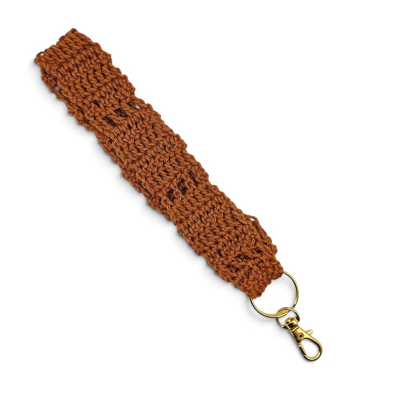 Handmade by Erika Liesel brown crochet wristlet keychain with a gold swivel clasp on a white background.