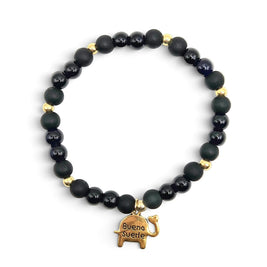 Handmade by Erika Liesel Buena Suerte bracelet with matte and glossy black glass beads and a gold elephant charm.