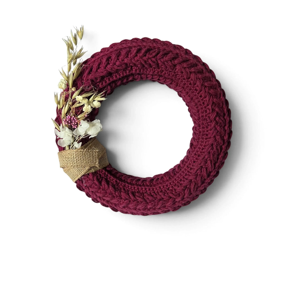 Handmade by Erika Liesel burgundy crochet wreath with dried floral accents and a rustic burlap ribbon detail.