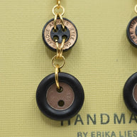 Handmade by Erika Liesel earrings featuring black and copper vintage button charms linked with gold-tone metal rings.