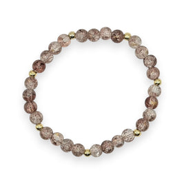 Handmade by Erika Liesel champagne crackle glass bead stretch bracelet with gold-tone accents on a white background.