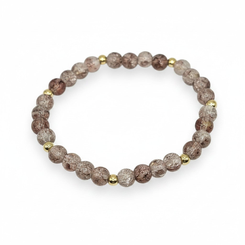 Handmade by Erika Liesel champagne crackle glass bead stretch bracelet with gold-tone accents on a white background