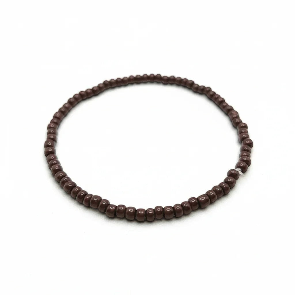 Handmade by Erika Liesel chocolate brown glass bead stretch bracelet on a white background.