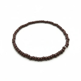 Handmade by Erika Liesel chocolate brown glass bead stretch bracelet on a white background.