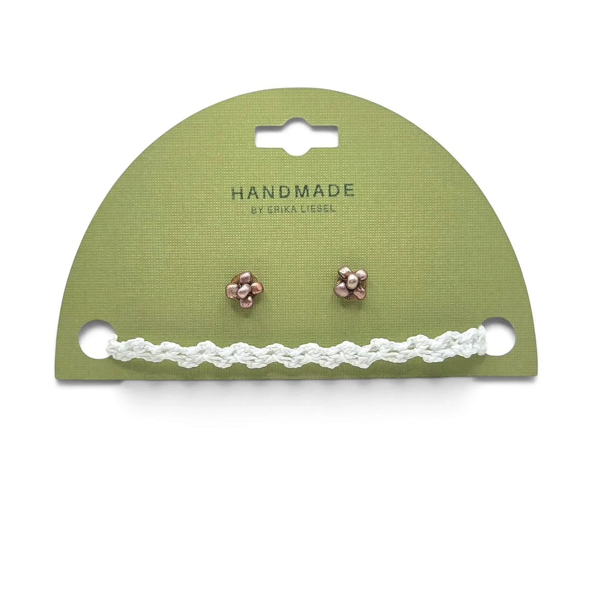 Handmade copper flower stud earrings with white crochet accent on green card