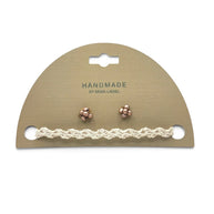 Handmade crochet bracelet and rose gold stud earrings on display card