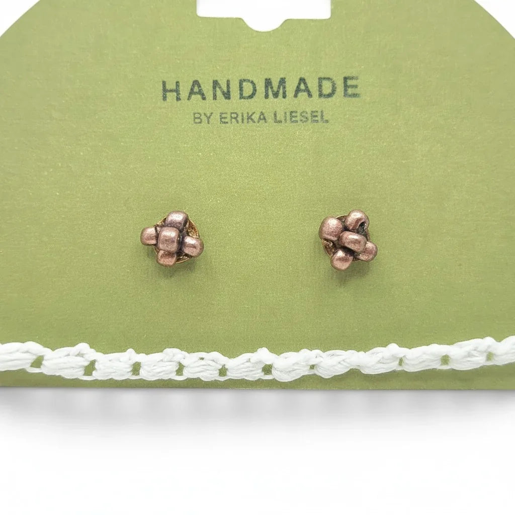 Handmade by Erika Liesel cluster stud earrings in copper tone displayed on a green card with a white crochet trim