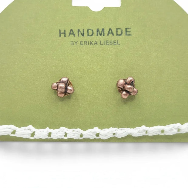 Handmade by Erika Liesel cluster stud earrings in copper tone displayed on a green card with a white crochet trim