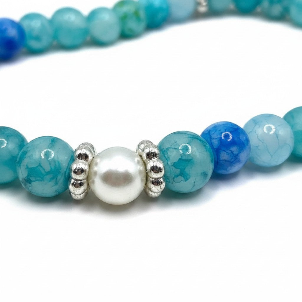 Handmade by Erika Liesel Coastal Pearl Bracelet featuring aqua and blue glass beads with faux pearl and silver spacers
