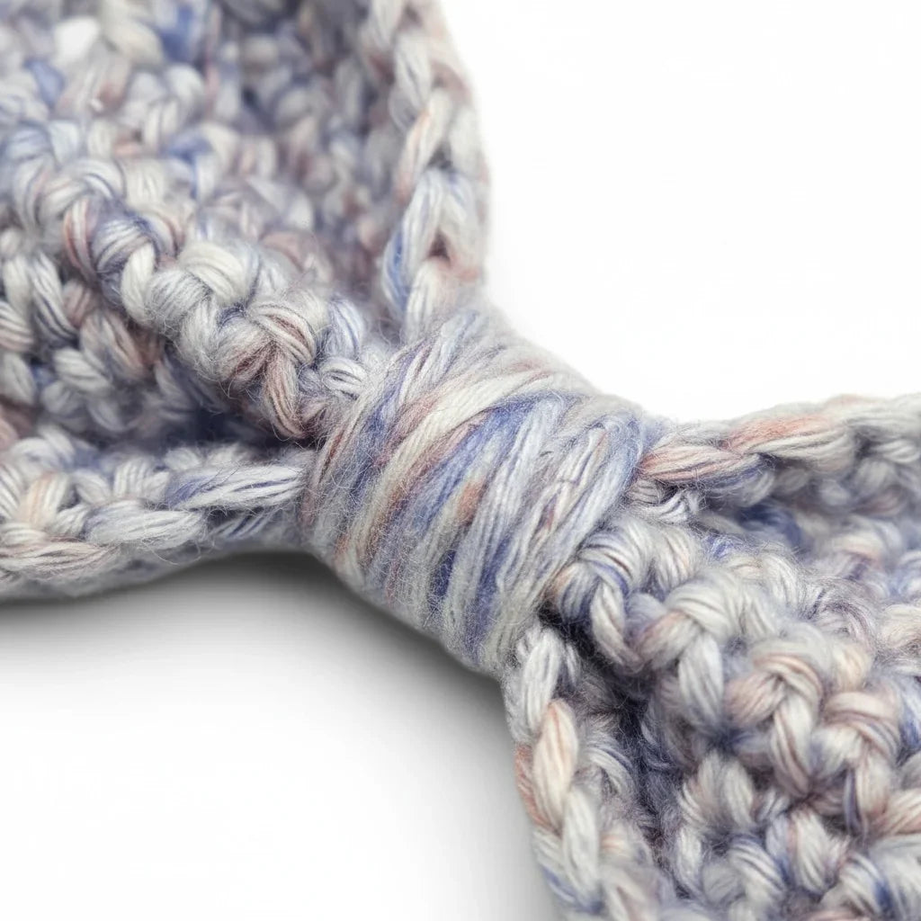 Handmade by Erika Liesel crochet bow barrette featuring soft blue and pink variegated yarn in a textured knit pattern.