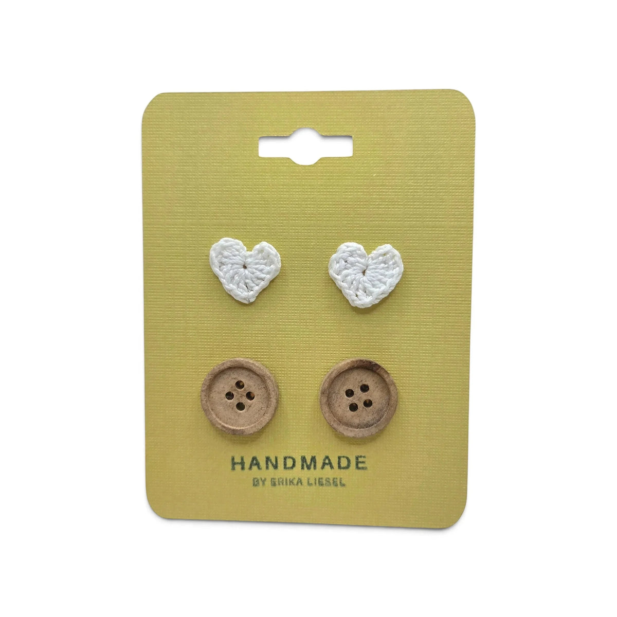 Handmade crochet heart and wooden buttons on yellow card, cozy craft supplies