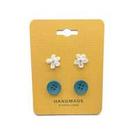 Handmade crochet flower and blue button earrings on yellow card, cozy craft gift