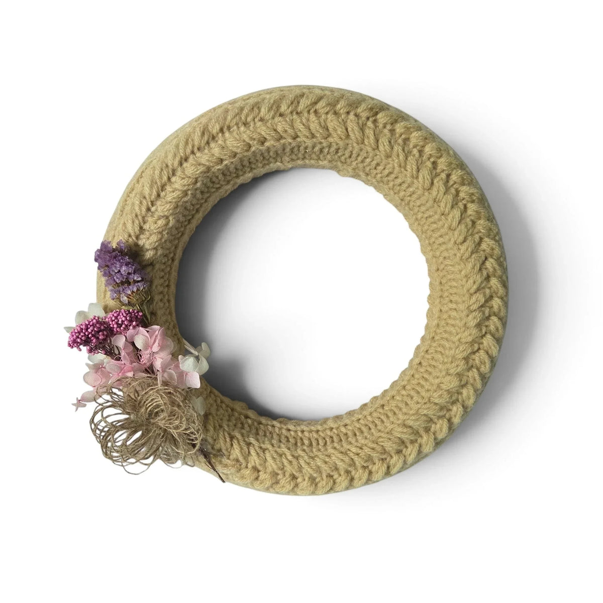 Handmade by Erika Liesel crochet floral wreath in neutral beige with dried purple and pink flower accents.