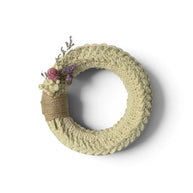 Handmade by Erika Liesel small crochet wreath in neutral cream with dried floral accents and burlap ribbon detail.