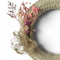 Handmade by Erika Liesel crochet wreath in neutral beige with pink dried floral accents and a rustic twine bow