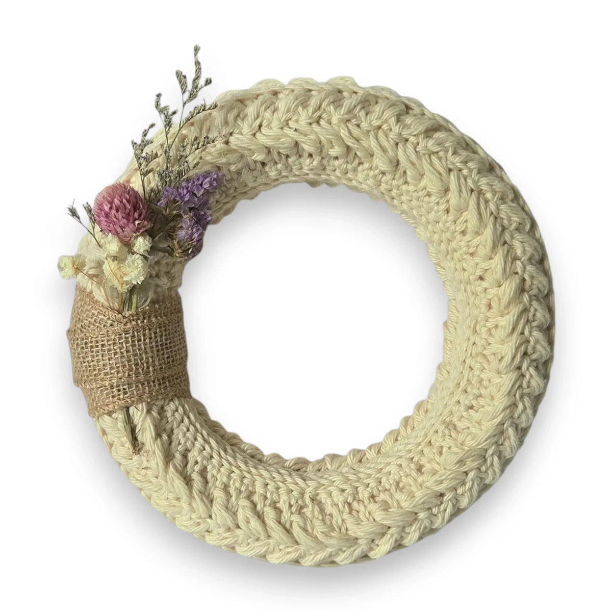 Handmade by Erika Liesel small crochet wreath in cream yarn with dried floral accents and a burlap ribbon detail.
