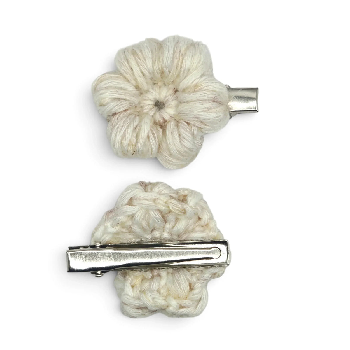 Handmade by Erika Liesel set of two cream crochet flower barrettes with silver alligator clips on white background