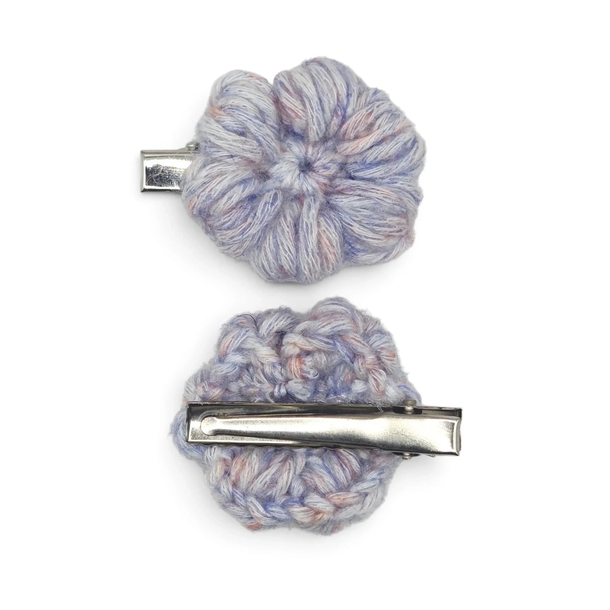 Handmade by Erika Liesel crochet flower barrettes in variegated blue and pink yarn with sturdy metal alligator clips.
