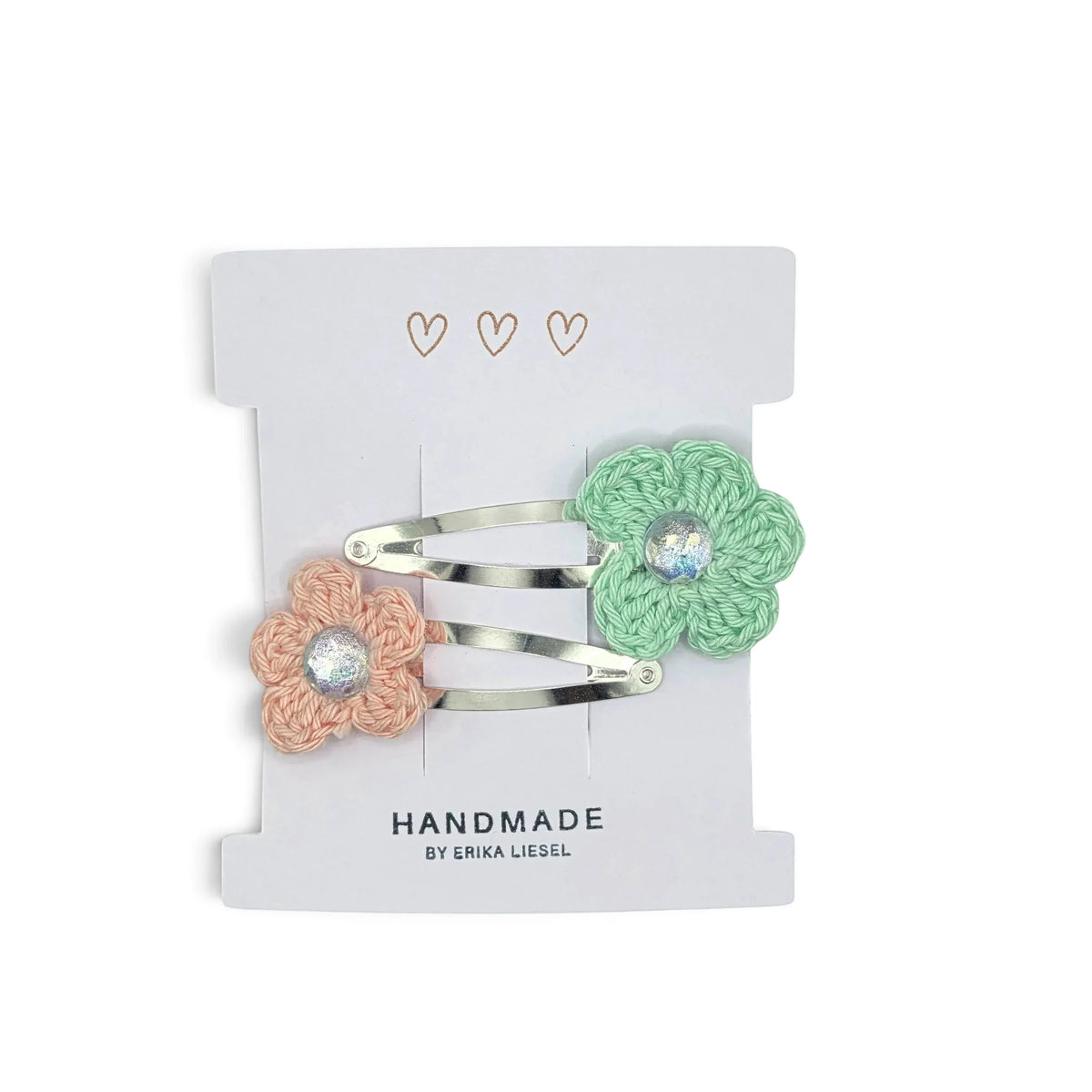 Handmade by Erika Liesel crochet flower snap clips in peach and mint green with sparkling rhinestone centers.
