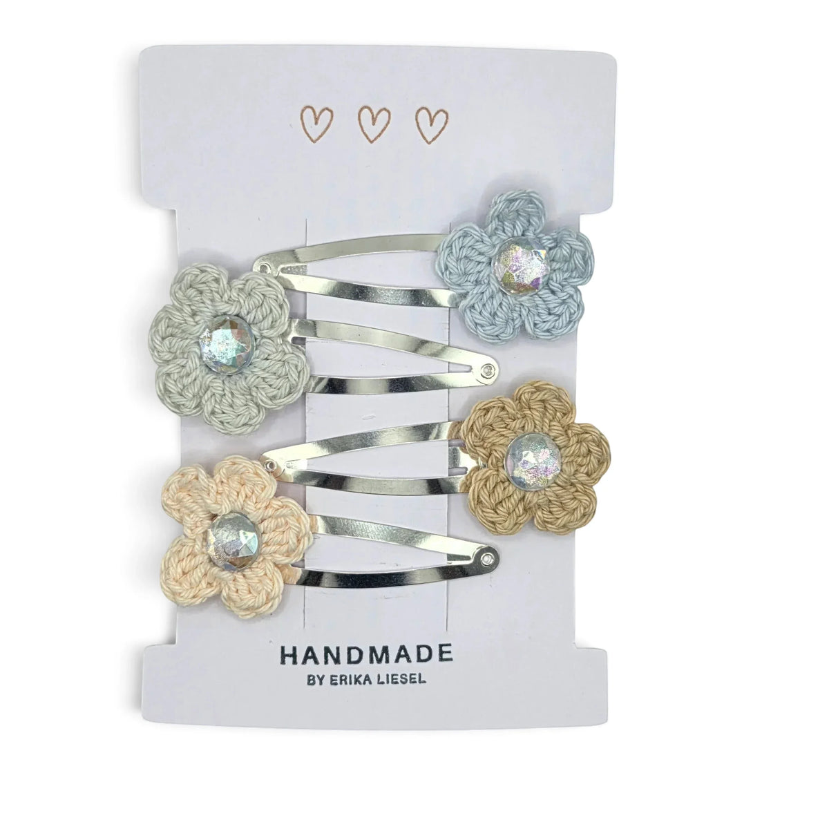Handmade by Erika Liesel crochet flower snap clips in pastel colors with sparkling rhinestone centers on a display card