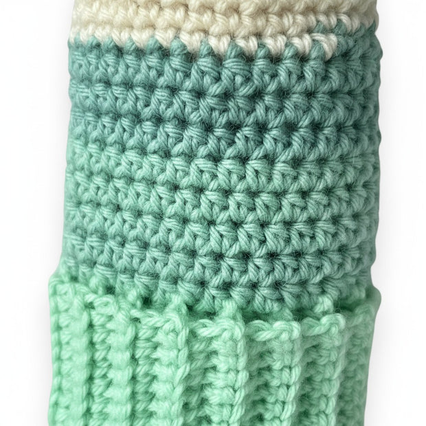 Handmade by Erika Liesel crochet gnome hat in cream and shades of green with a textured ribbed brim