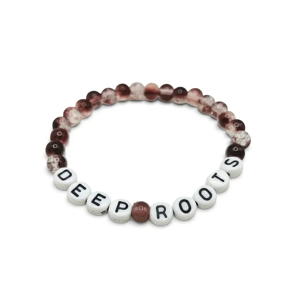 Handmade by Erika Liesel Deep Roots stretch bracelet with smoky brown crackle glass beads and white letter beads.