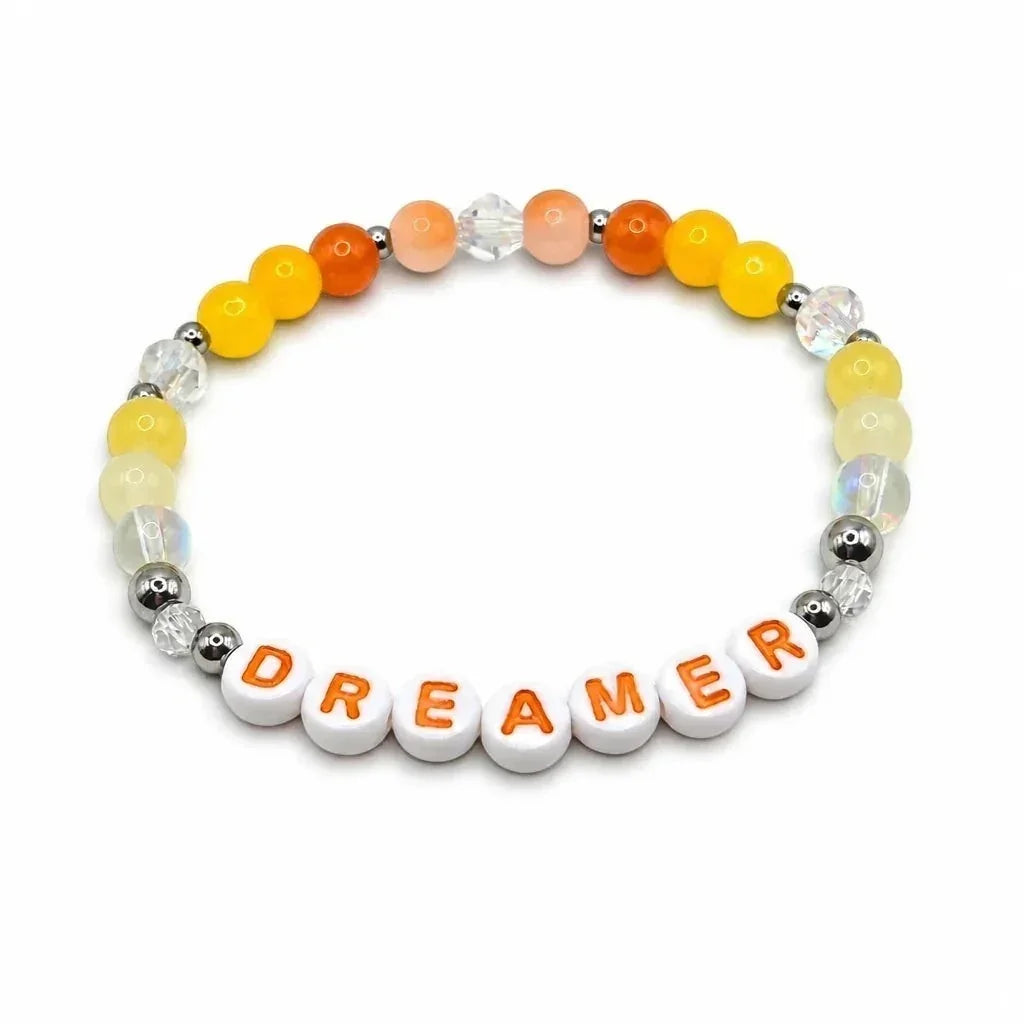 Handmade by Erika Liesel Dreamer stretch bracelet with yellow and orange crystal beads and sterling silver accents.