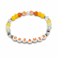 Handmade by Erika Liesel Dreamer stretch bracelet with yellow and orange crystal beads and sterling silver accents.