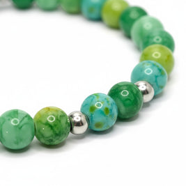 Handmade by Erika Liesel Emerald Garden stretch bracelet with green glass beads, faux pearls, and rhinestone spacers.